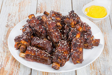 Chinese spicy fried  Ribs on white dish, close-up