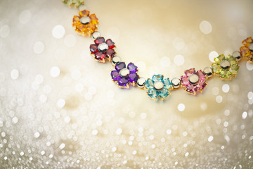 flower necklace on shiny bokeh background