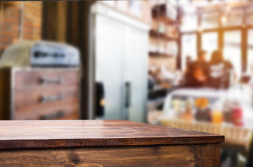 Selected focus empty brown wooden table and Coffee shop blur bac
