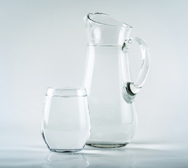 Jug and glass on white background