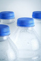 Wet plastic water bottles isolated on white background