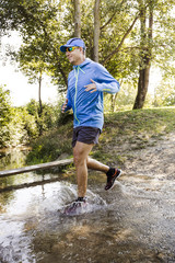 young man jogging at the woods