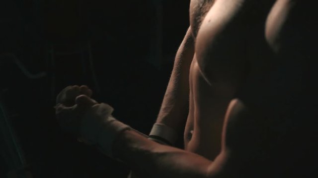 Close-up muscle man use powerlifting stripe , lowlight