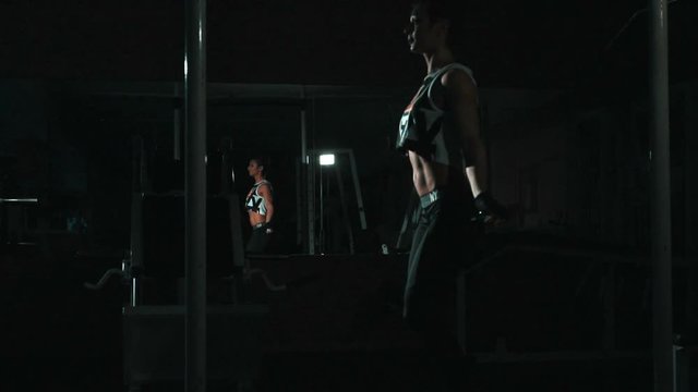 Slowmo ,skipping woman training at gym, lowlight