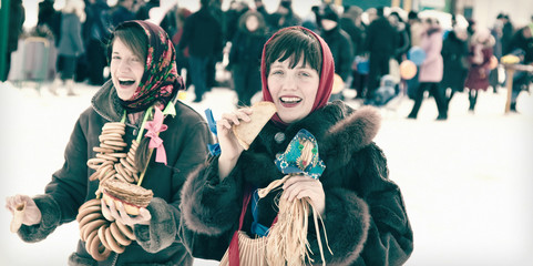 Women tasting pancake  during  Shrovetide