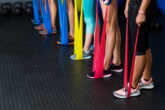 Athletes exercising with resistance band
