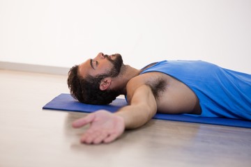 Fototapeta na wymiar Man in yoga corpse pose