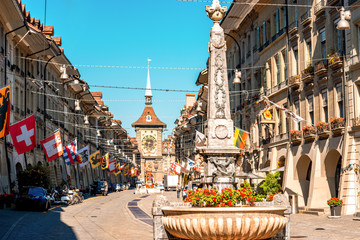 Street view on Kramgasse with fountain and clock tower in the old town of Bern city. It is a...
