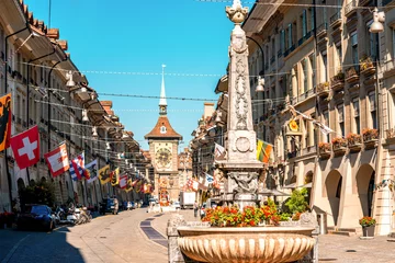 Gordijnen Street view on Kramgasse with fountain and clock tower in the old town of Bern city. It is a popular shopping street and medieval city centre of Bern, Switzerland © rh2010