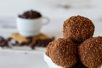 Brown ball shaped desserts. Candies with crumbs. Cookies and sugar. Sweet dish from russian cuisine.