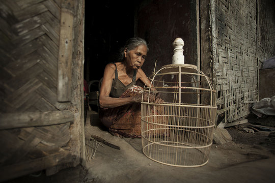 Senior woman making a bird cage, Jember, East Java, Indonesia