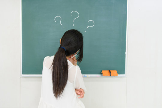 Girl and Question mark written on the chalkboard