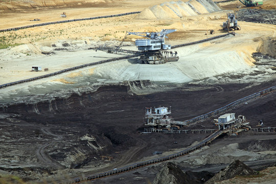 open pit coal mine with heavy machinery