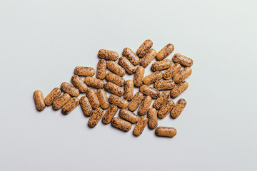 Pile vitamin tablets on a white table