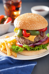 homemade cheese burger with peppers tomato onion