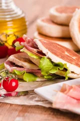 Foto auf Acrylglas Tigella bread stuffed with ham and lettuce. © Mi.Ti.