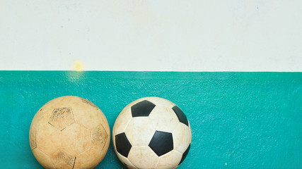 Old footballs with grunge cement wall