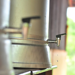 Close up water droplet on stainless steel cooler valve, Save water concept