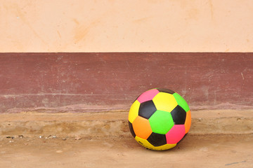 Old colorful football on grunge cement floor