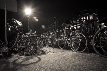 Night street with bicycles, Amsterdam, Netherlands. Sepia.
