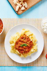 Tagliatelle with Bolognese sauce in white dish 