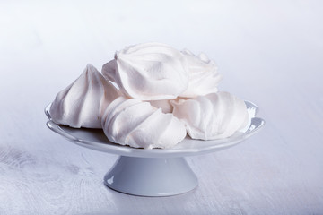 Heap of fluffy meringue on the plateau