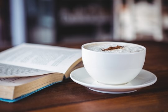 Coffee cup and book on a table
