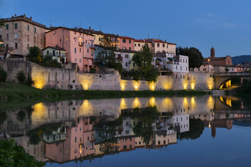 Fototapeta na wymiar Old city reflection in Tevere river, Umbertide, Italy