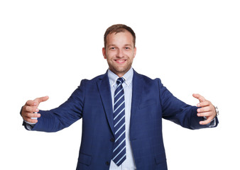 Young happy businessman holds something isolated on white