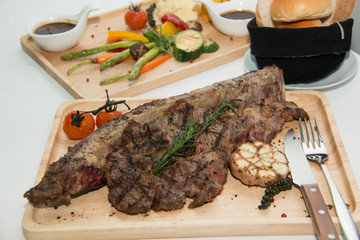  grilled  tomahawk beef steak cut  with fresh rosemary and tomat