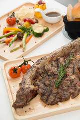  grilled  tomahawk beef steak cut  with fresh rosemary and tomat