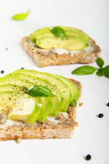 Sandwich with avocado slices and basil