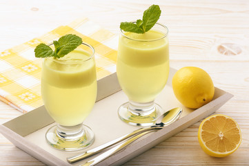 Lemon jelly with mousse on white tray.