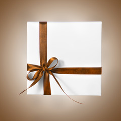 Isolated Holiday Present White Box with Brown Orange Yellow Ribbon on a gradient background