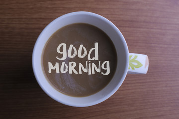 Message good morning coffee cup and business strategy on wooden