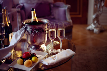 Fototapeta na wymiar Still life, romantic dinner, two glasses and champagne in the ice bucket. Celebration or holiday