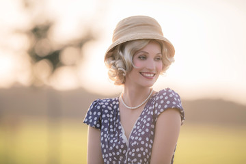 Smiling woman wearing retro 1920s clothing. Standing in rural su