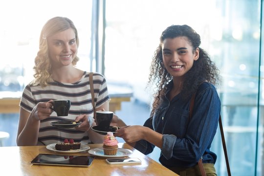 Smiling woman having coffee in café