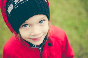 cute girl in a jacket and hat on the stree