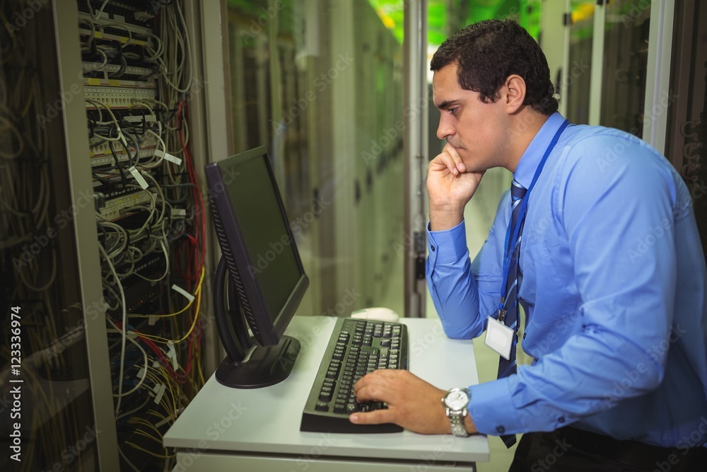 Aufkleber Technician working on personal computer while analyzing server