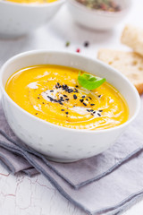 Homemade vegetable soup with pumpkin with cream and black sesame, closeup