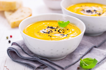 Homemade vegetable soup with pumpkin with cream and black sesame, closeup