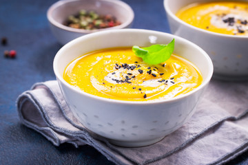 Homemade vegetable soup with pumpkin with cream and black sesame, closeup