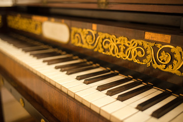 Fototapeta na wymiar Old piano keyboard with floral ornament