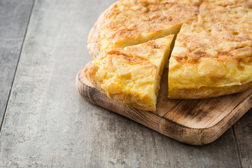 Traditional spanish omelette and wine on wooden table

