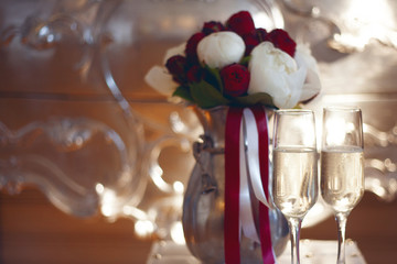 Bridal bouquet and two glasses of champagne