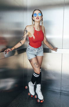 Sexy young girl posing in elevator car