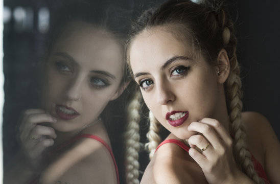 Sensual woman with braid looking at camera
