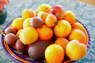 Plate with fresh mixed fruits on the table