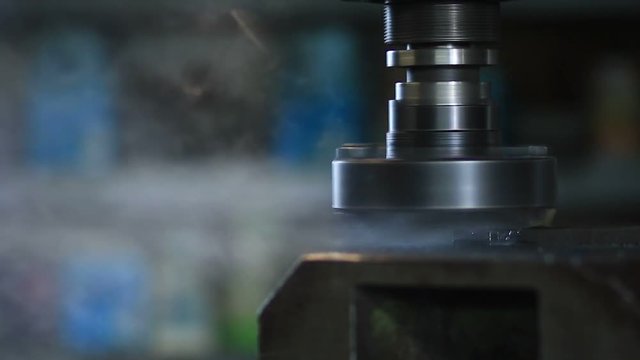 Old industrial milling machine cutting metal